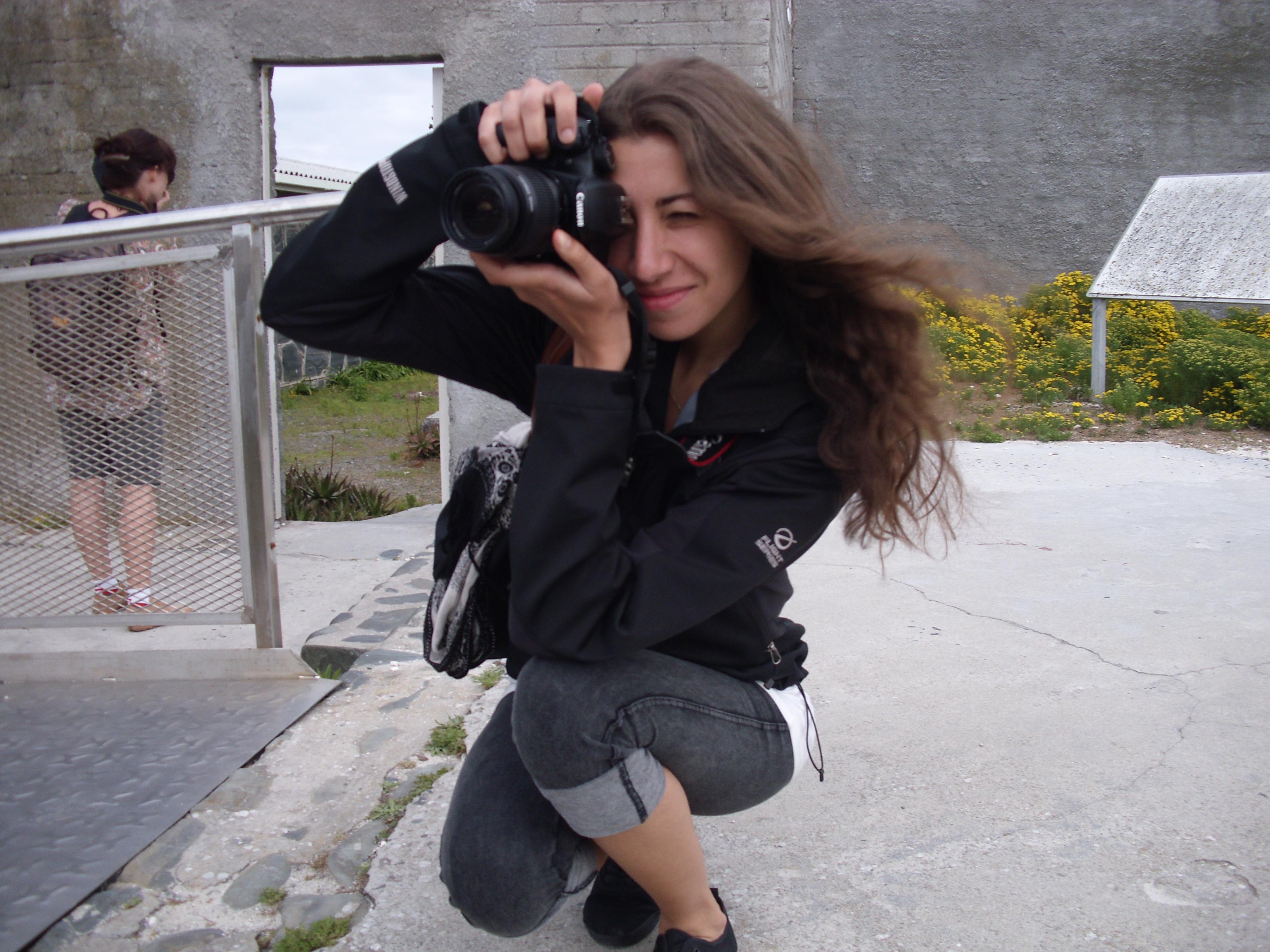 A Projects Abroad journalism intern takes a picture at her placement in South Africa A journalism intern in South Africa collecting photographs for a story
